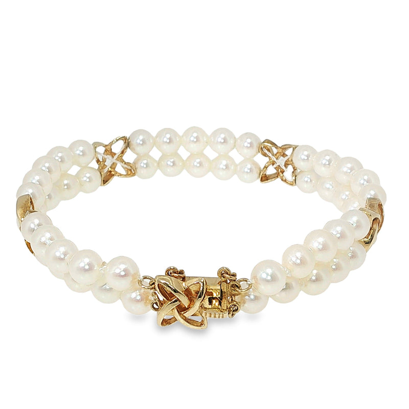 Mikimoto double-strand Akoya pearl bracelet with yellow gold star-style stations and 5.5–6 MM pearls.