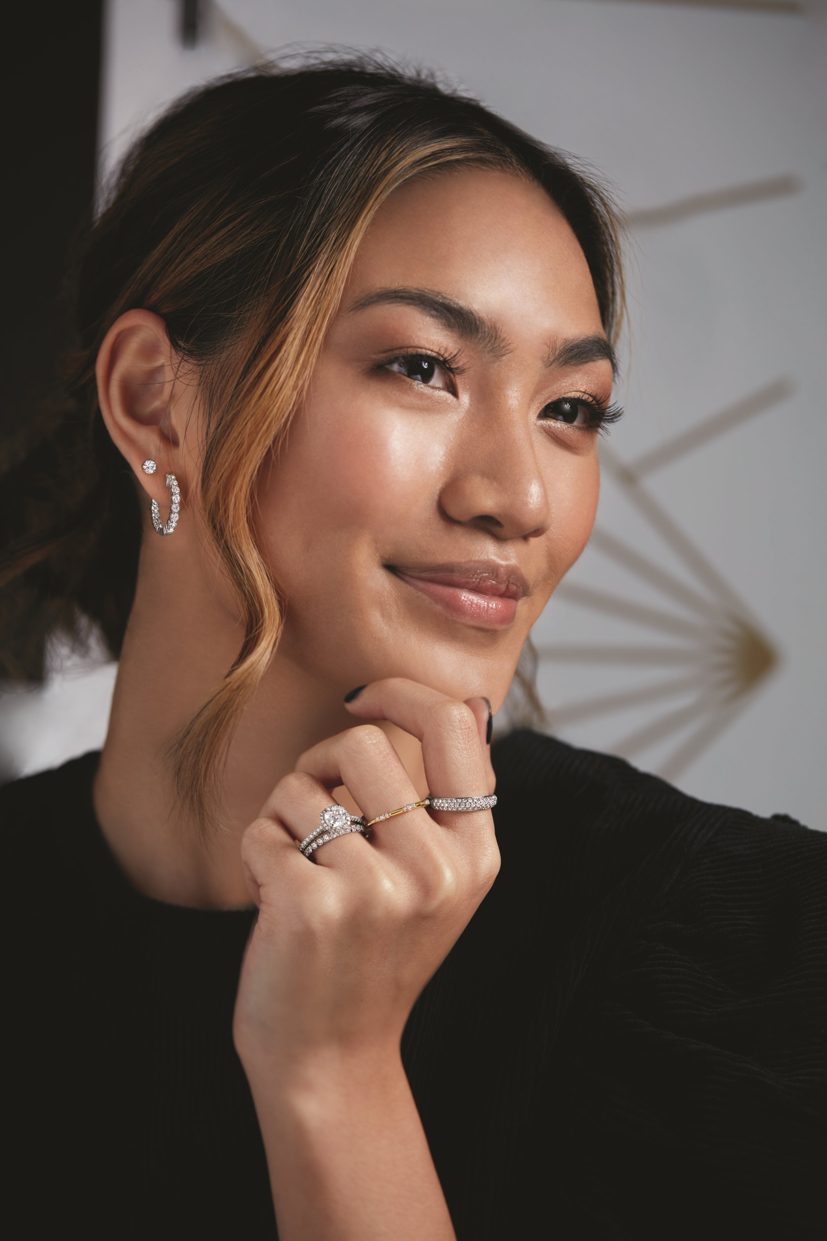 Woman wearing coordinating diamond earrings and rings