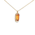 14K yellow gold pendant with an elongated golden-orange citrine framed by sweeping curves and diamond accents.