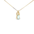 14K yellow gold swirl pendant with a pear-shaped pale blue aquamarine and three diamond accents.