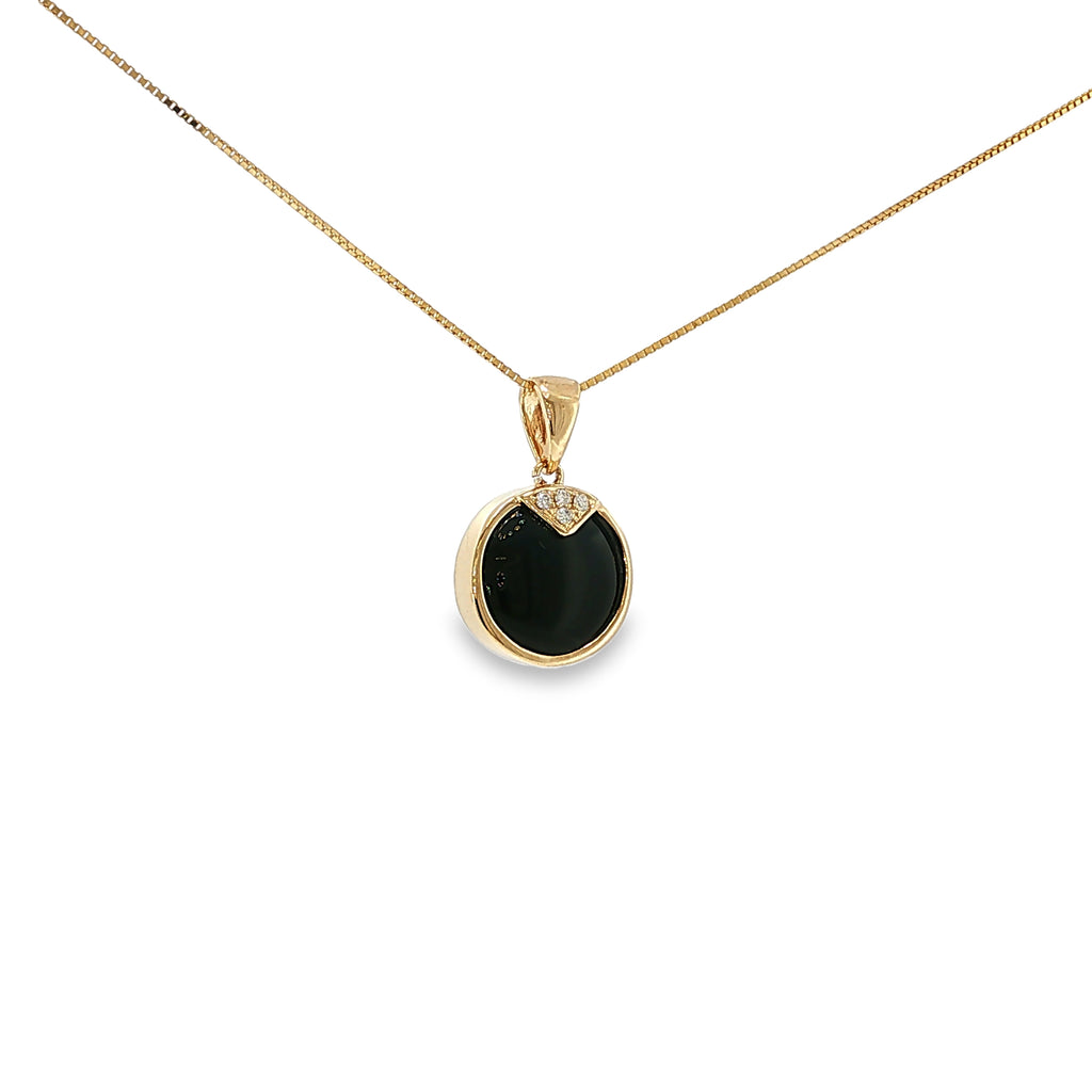 14K yellow gold pendant with a round black onyx center and four diamond accents.