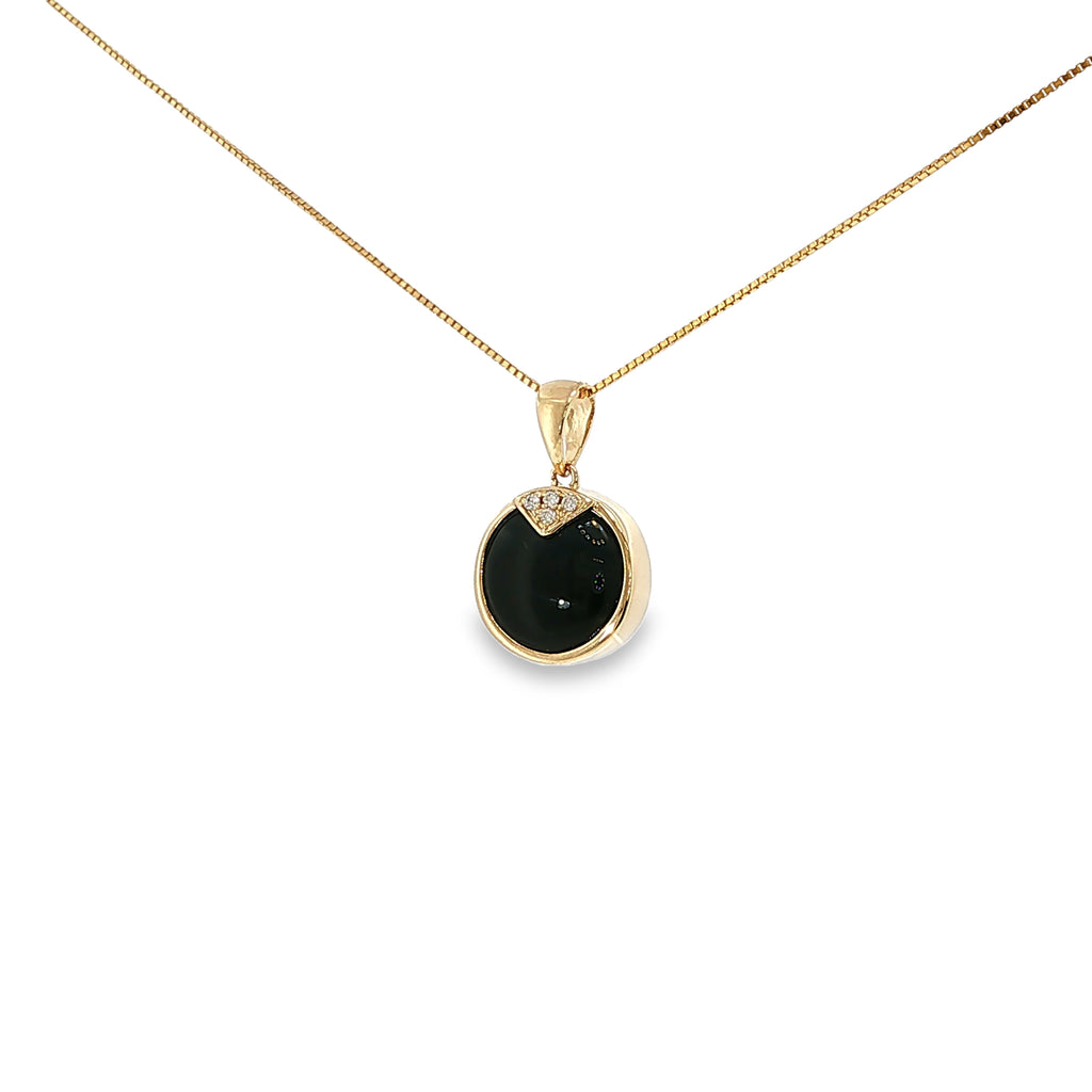 14K yellow gold pendant with a round black onyx center and four diamond accents.