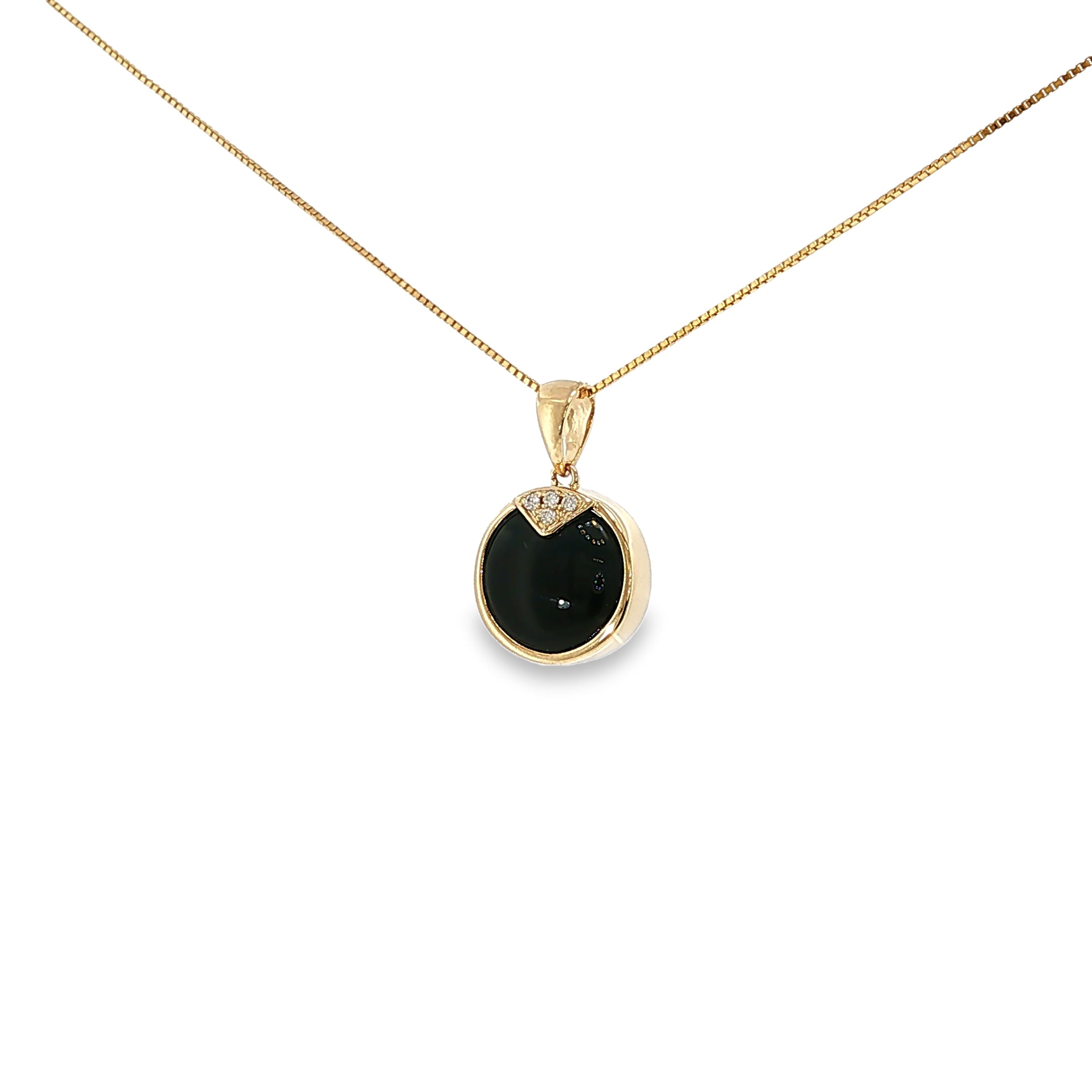 14K yellow gold pendant with a round black onyx center and four diamond accents.