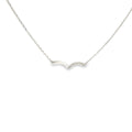 14K white gold asymmetrical wave necklace with a flowing polished design and a row of diamond accents.