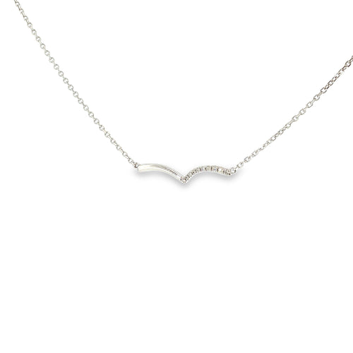 14K white gold asymmetrical wave necklace with a flowing polished design and a row of diamond accents.