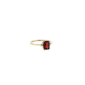 14K yellow gold three-stone ring with a checkerboard-cut deep red garnet flanked by two diamond accents.