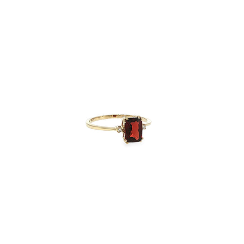 14K yellow gold three-stone ring with a checkerboard-cut deep red garnet flanked by two diamond accents.