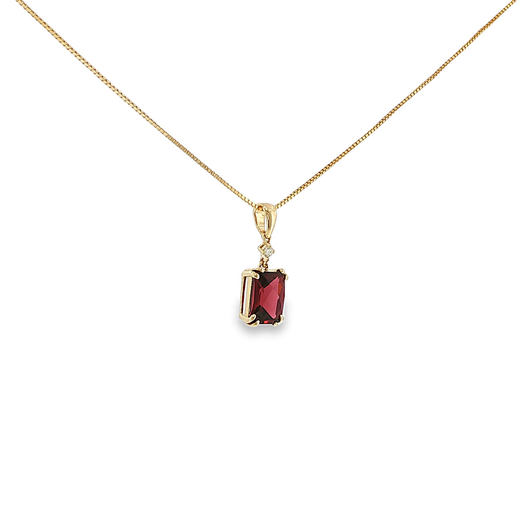 14K yellow gold pendant with a checkerboard-cut deep red garnet and a single diamond accent.
