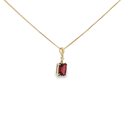 14K yellow gold pendant with a checkerboard-cut deep red garnet and a single diamond accent.