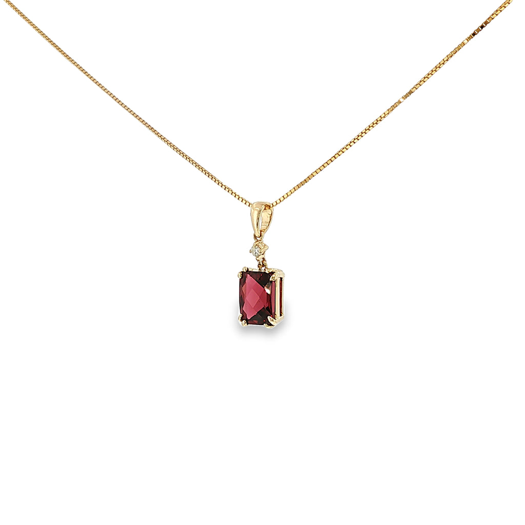 14K yellow gold pendant with a checkerboard-cut deep red garnet and a single diamond accent.