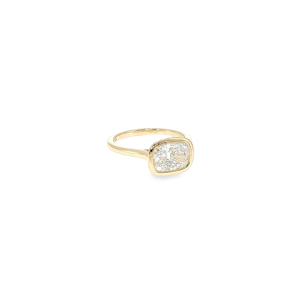 14K yellow gold ring with a cushion-cut lab-grown diamond in a smooth bezel setting.