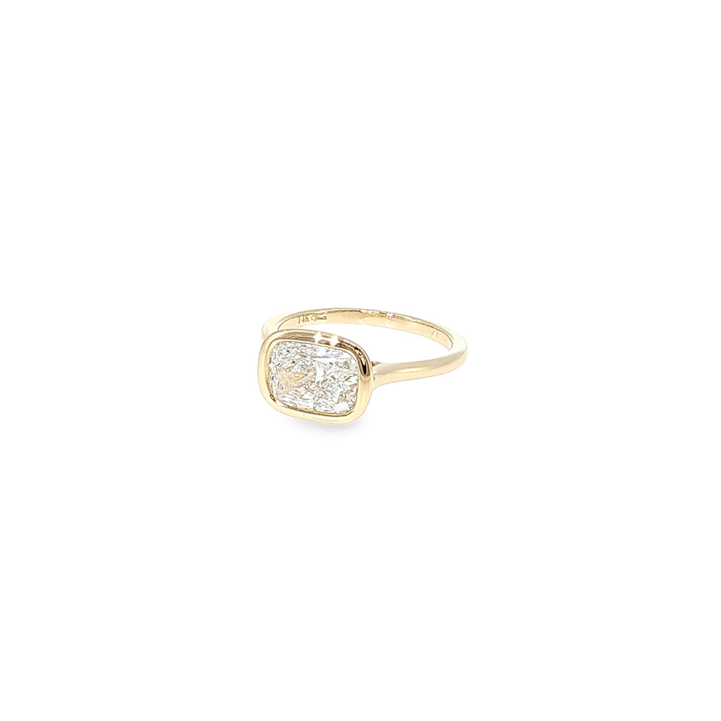 14K yellow gold ring with a cushion-cut lab-grown diamond in a smooth bezel setting.