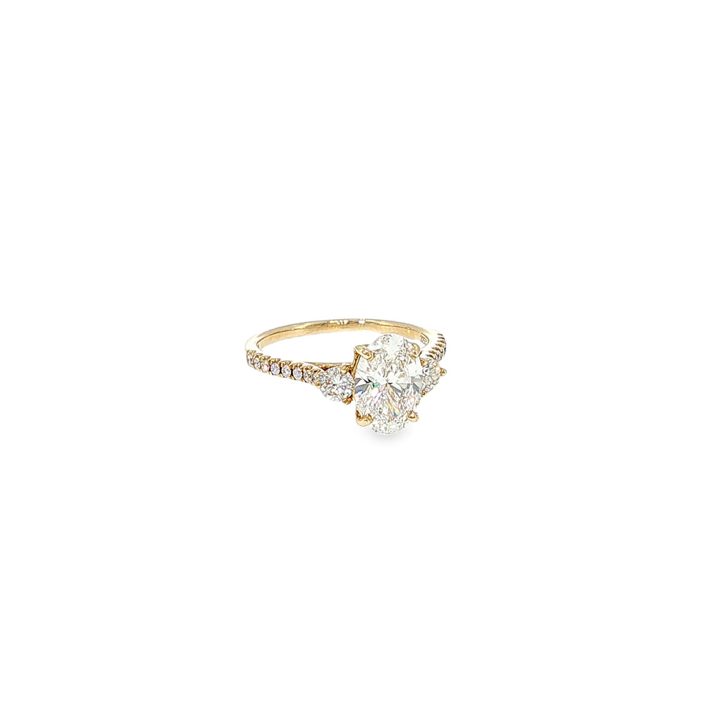 14K yellow gold engagement ring with an oval lab-grown diamond center and natural round diamond accents.