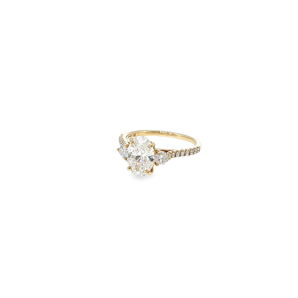 14K yellow gold engagement ring with an oval lab-grown diamond center and natural round diamond accents.