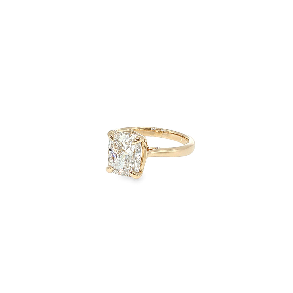 14K yellow gold solitaire engagement ring with a cushion-cut lab-grown diamond center.