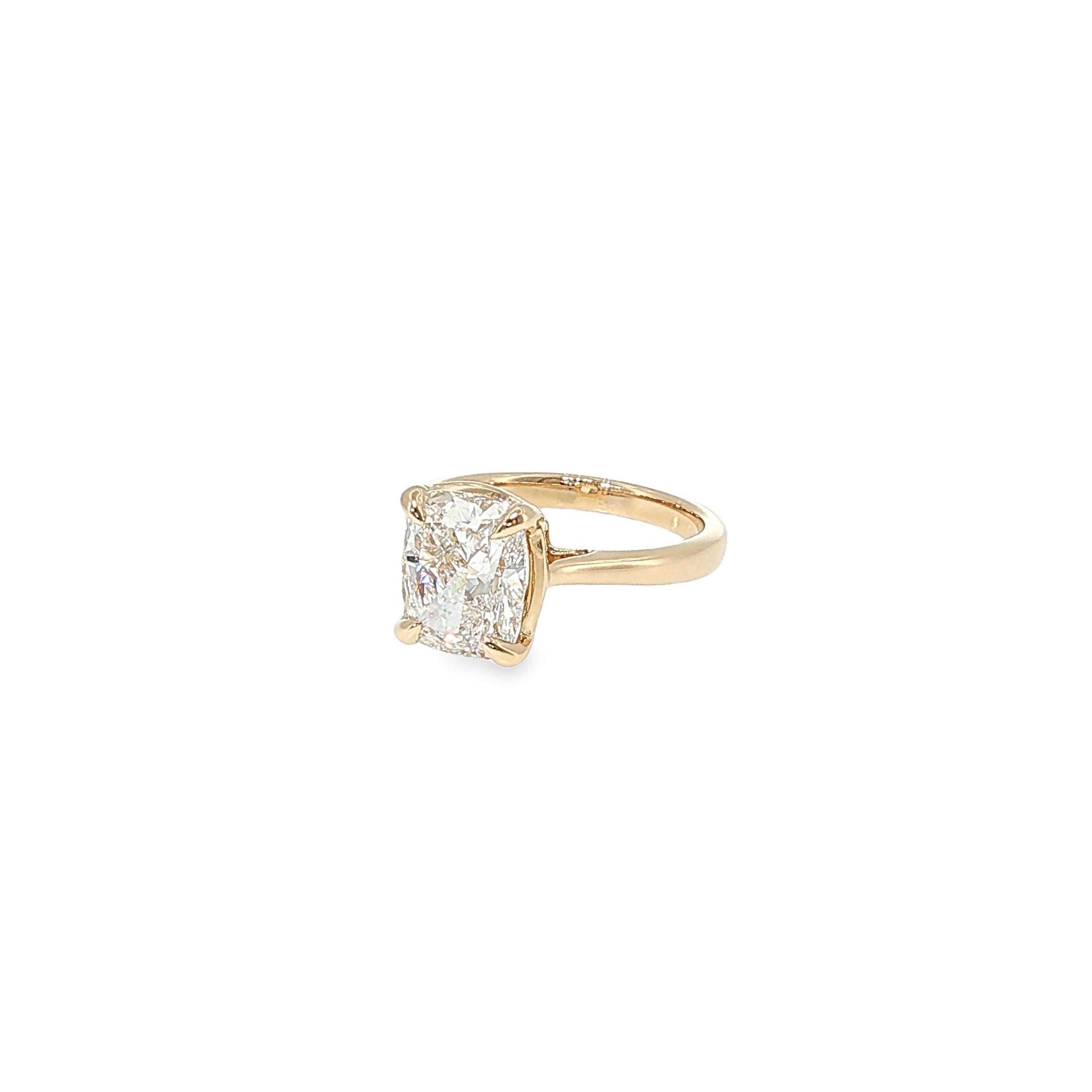 14K yellow gold solitaire engagement ring with a cushion-cut lab-grown diamond center.