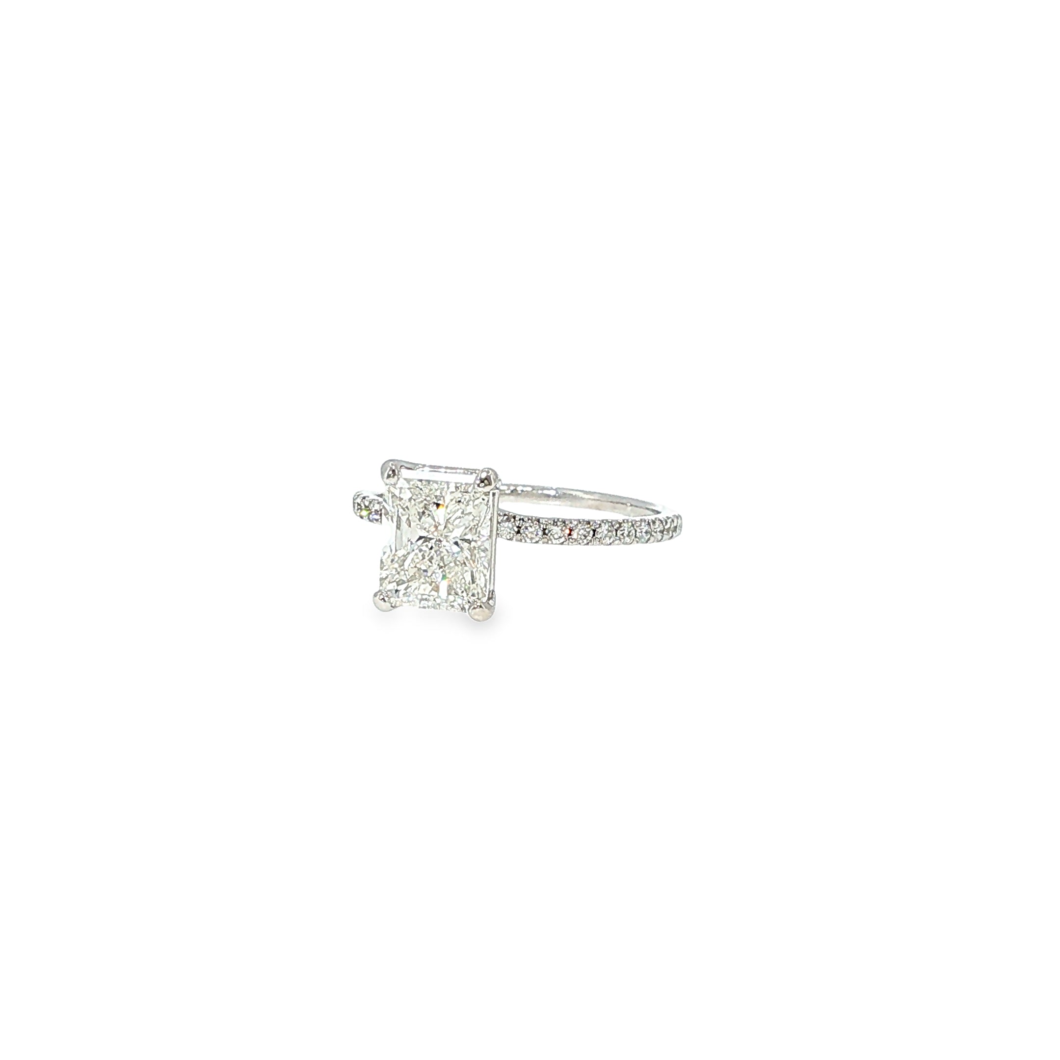 14K white gold engagement ring with a radiant-cut diamond center and round diamond accents along the band.