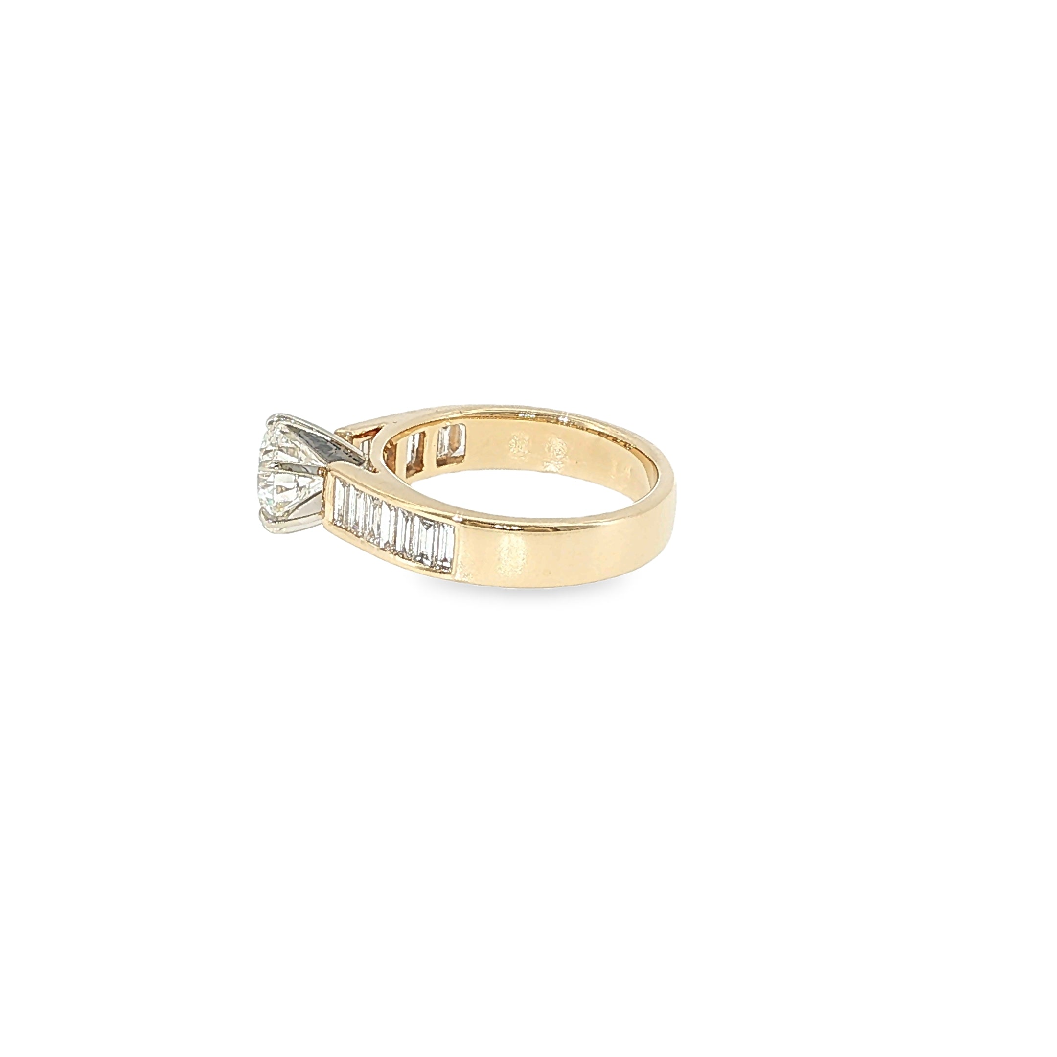 14K yellow gold engagement ring with a round brilliant diamond center and channel-set baguette diamond accents.