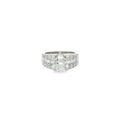 14K white gold engagement ring with a round brilliant diamond center and multiple rows of baguette and round diamonds.