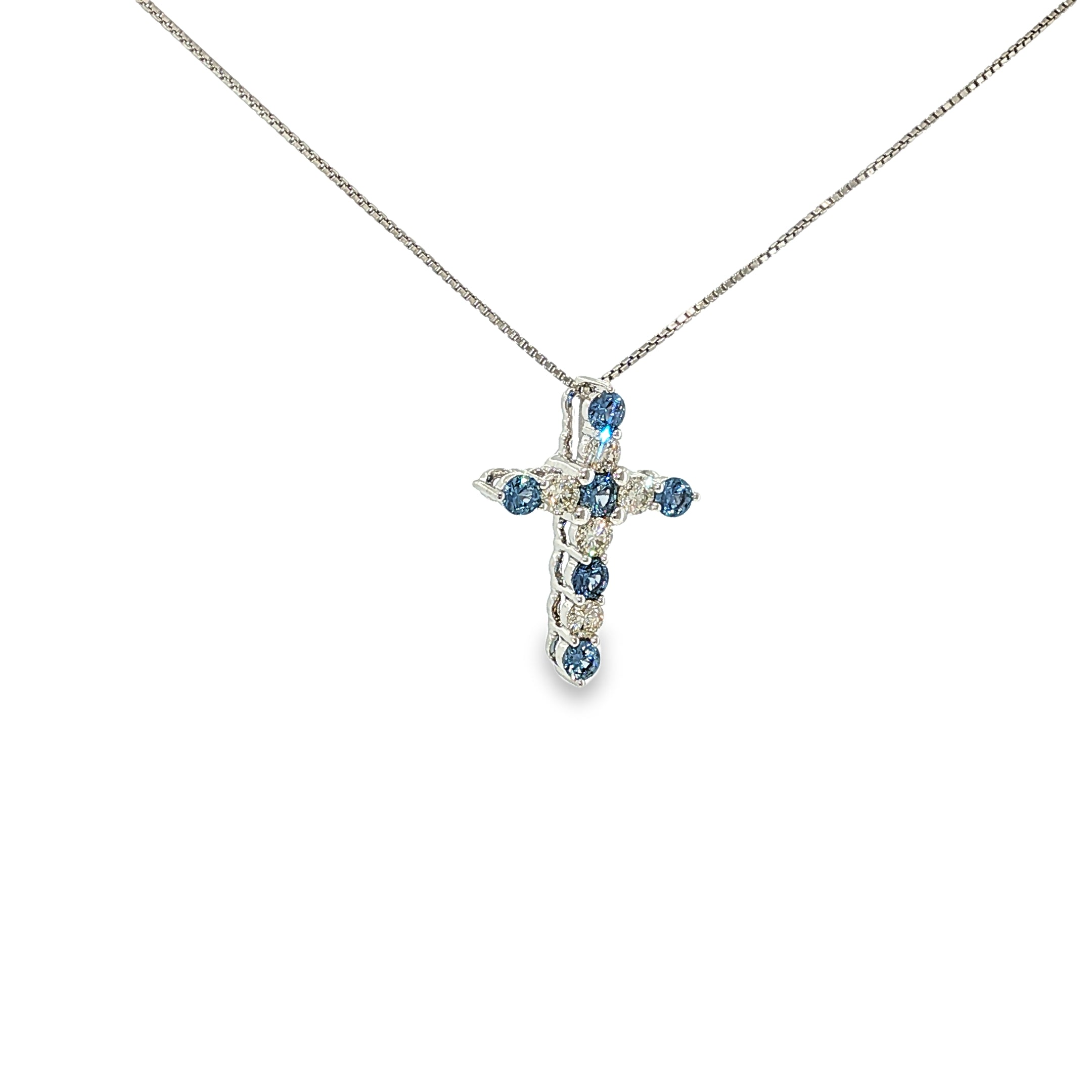 14K white gold cross necklace with alternating blue Montana Yogo sapphires and diamonds.