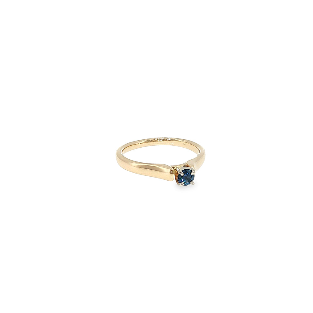 14K yellow gold cathedral solitaire ring with a round Montana Yogo sapphire center.