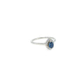 14K white gold ring with a pear-shaped Montana Yogo sapphire surrounded by a curved diamond halo.