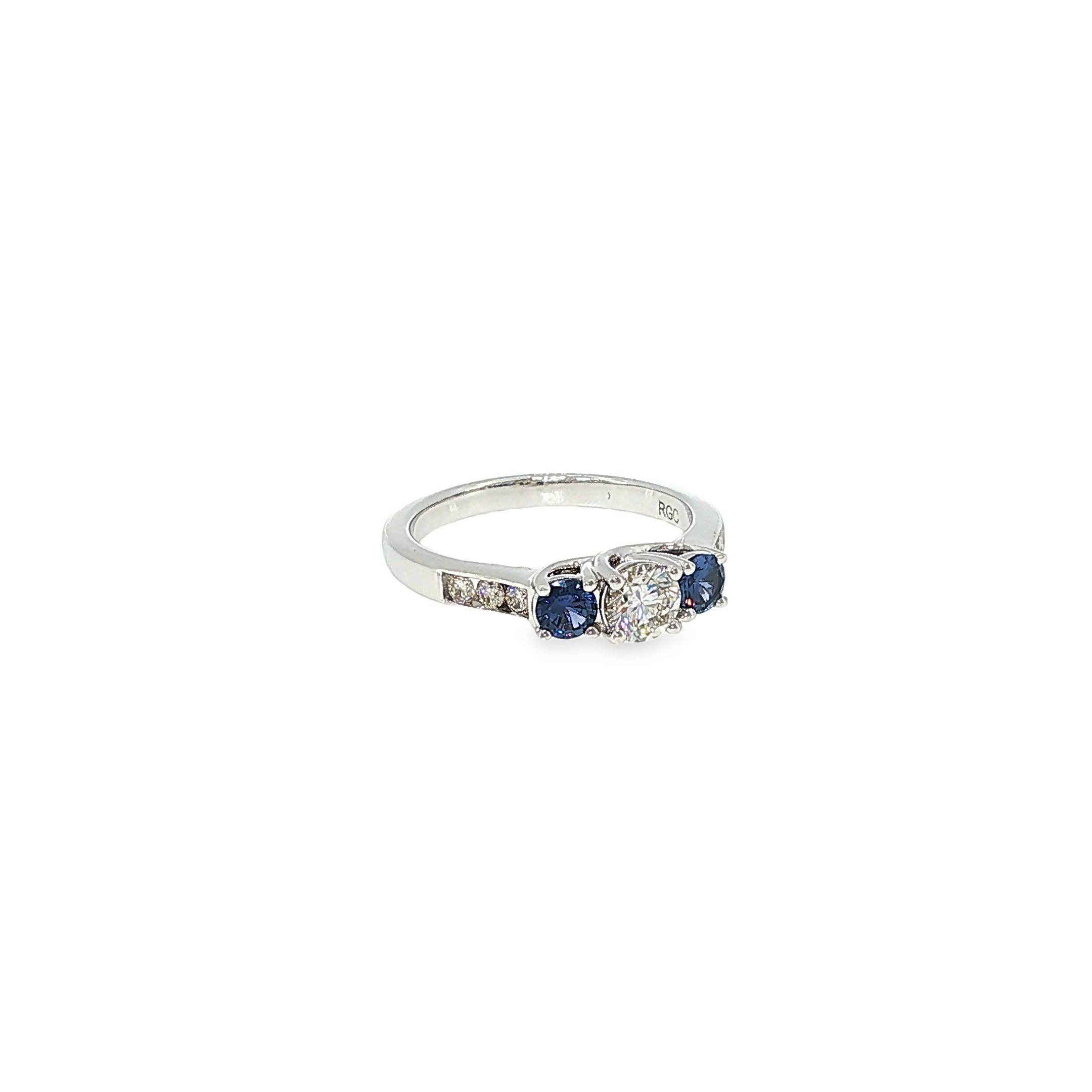 14K white gold three-stone ring with a round diamond center and two round Montana Yogo sapphires.