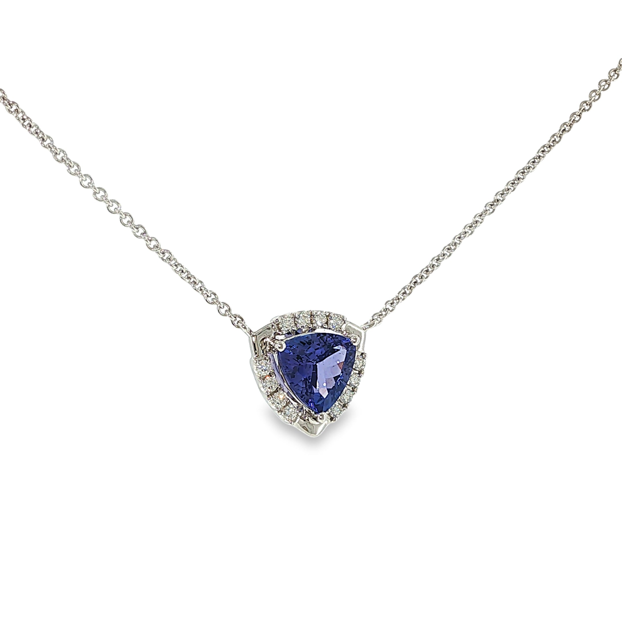 14K white gold necklace with a trillion-cut tanzanite surrounded by a diamond halo, shown angled to the left.
