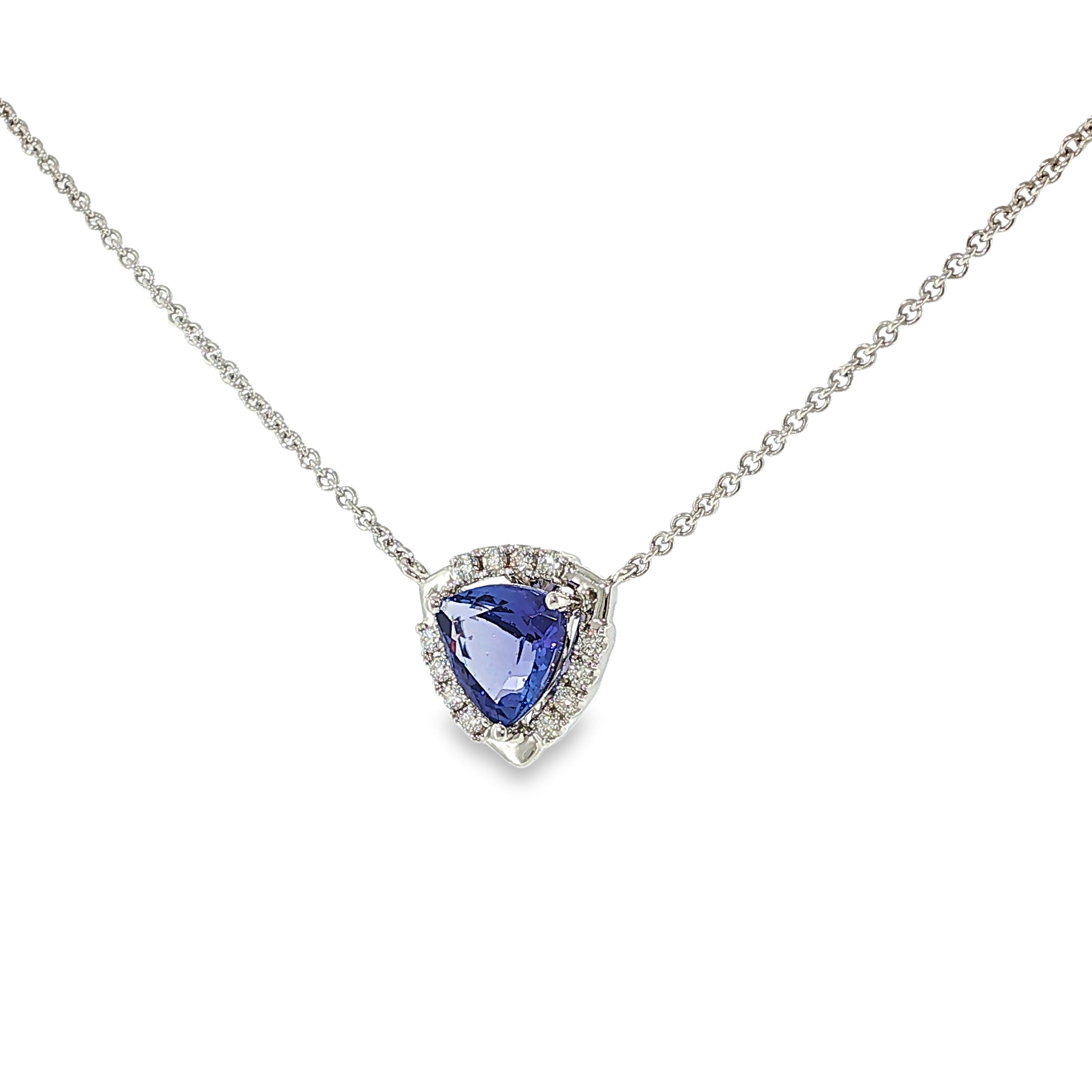14K white gold necklace with a trillion-cut tanzanite surrounded by a diamond halo, shown angled to the right.