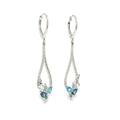 14K white gold pear-frame dangle earrings with mixed blue topaz gemstones and diamond accents, shown angled to the left.