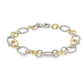 Sterling silver and 18K yellow gold bracelet with twisted and polished multi-shape links, shown angled to the left.
