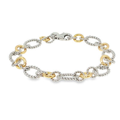 Sterling silver and 18K yellow gold bracelet with twisted and polished multi-shape links, shown angled to the left.