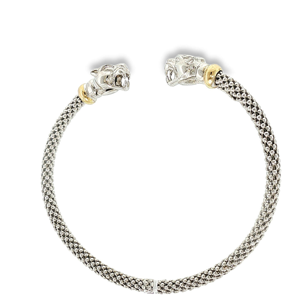 Woven sterling silver cuff bracelet with sculpted panther heads, diamond accents, and 18K yellow gold details, shown angled to the left.