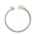 Woven sterling silver cuff bracelet with sculpted panther heads, diamond accents, and 18K yellow gold details, shown angled to the left.
