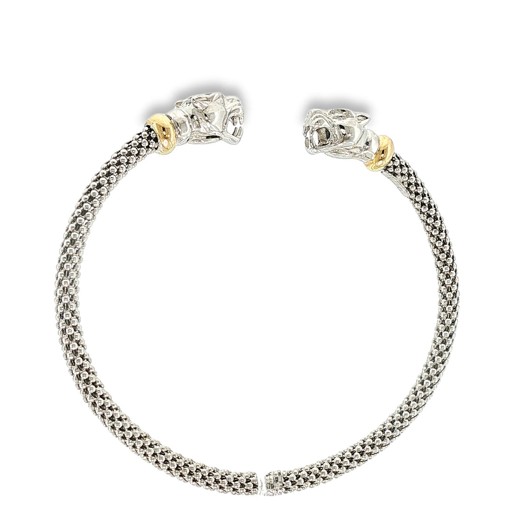 Woven sterling silver cuff bracelet with sculpted panther heads, diamond accents, and 18K yellow gold details, shown angled to the right.