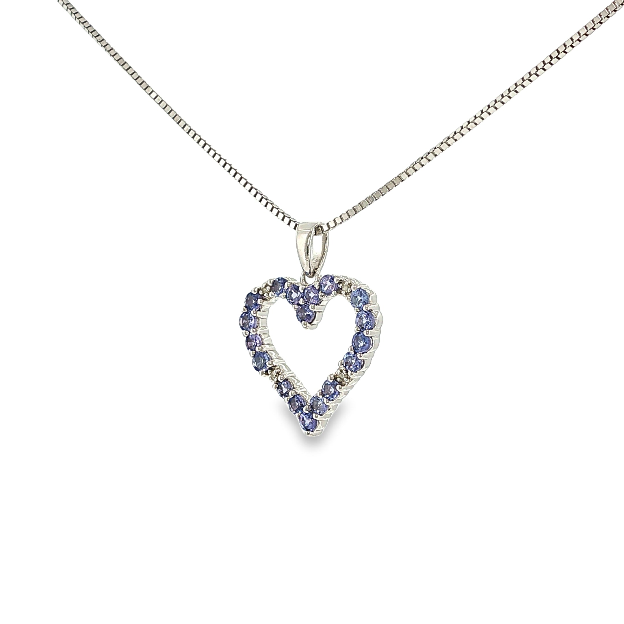 Sterling silver open heart pendant with tanzanite gemstones and a small diamond accent.