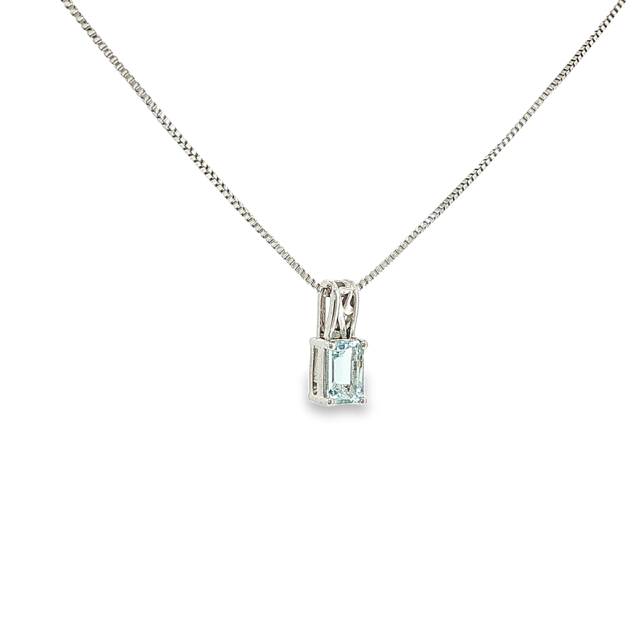 Sterling silver pendant with an emerald-cut pale blue aquamarine in a four-prong solitaire setting.