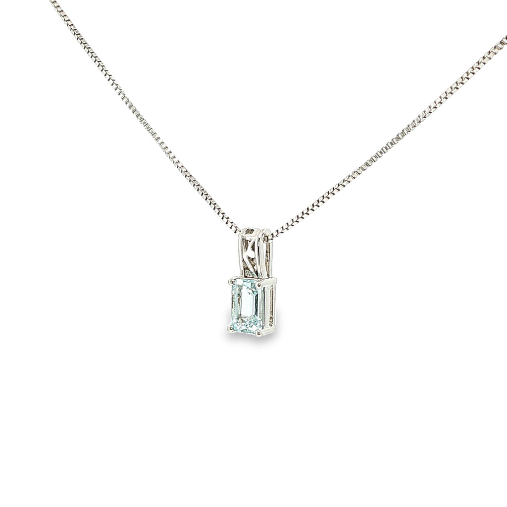 Sterling silver pendant with an emerald-cut pale blue aquamarine in a four-prong solitaire setting.