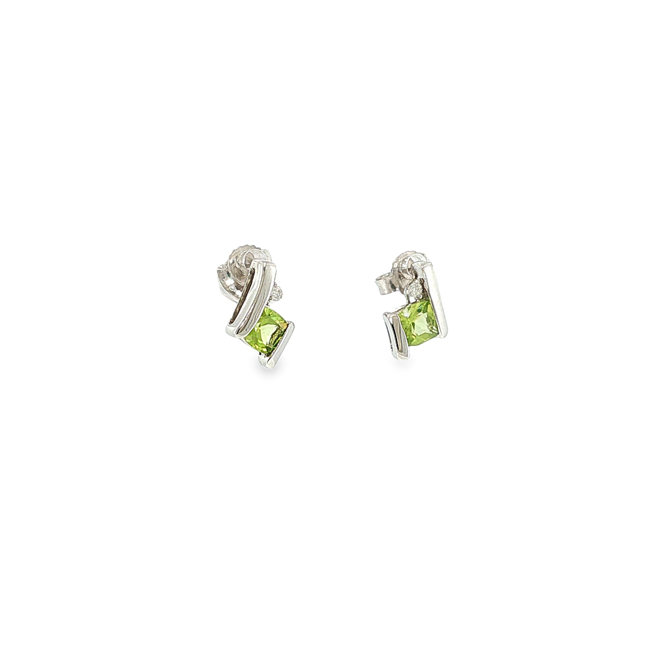Sterling silver stud earrings with cushion-cut green peridots framed by curved silver and diamond accents.
