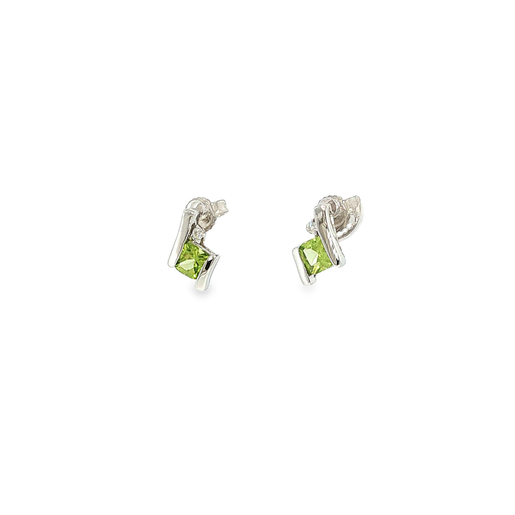 Sterling silver stud earrings with cushion-cut green peridots framed by curved silver and diamond accents.