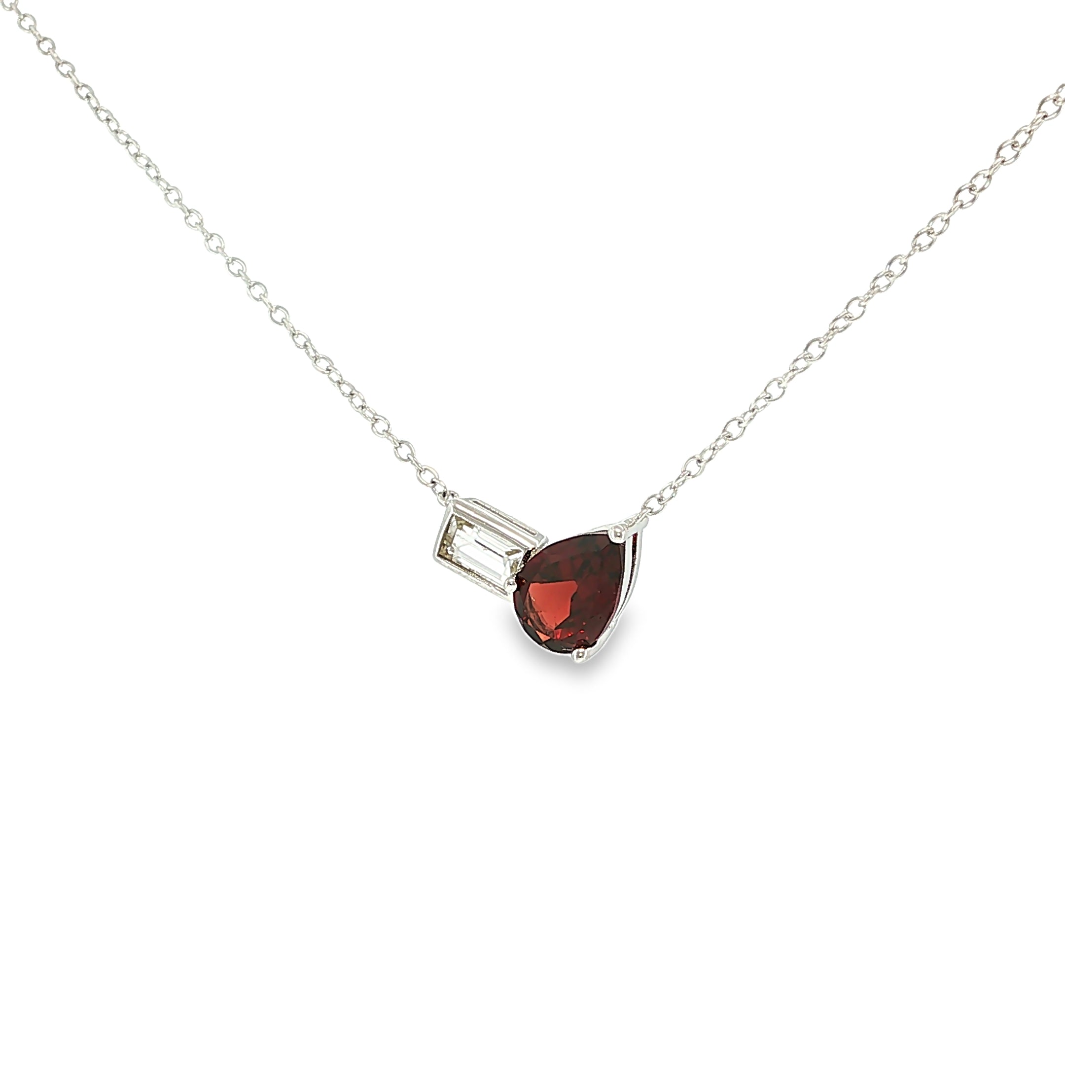 Sterling silver necklace with a pear-shaped red garnet and emerald-cut white topaz in an asymmetrical design.