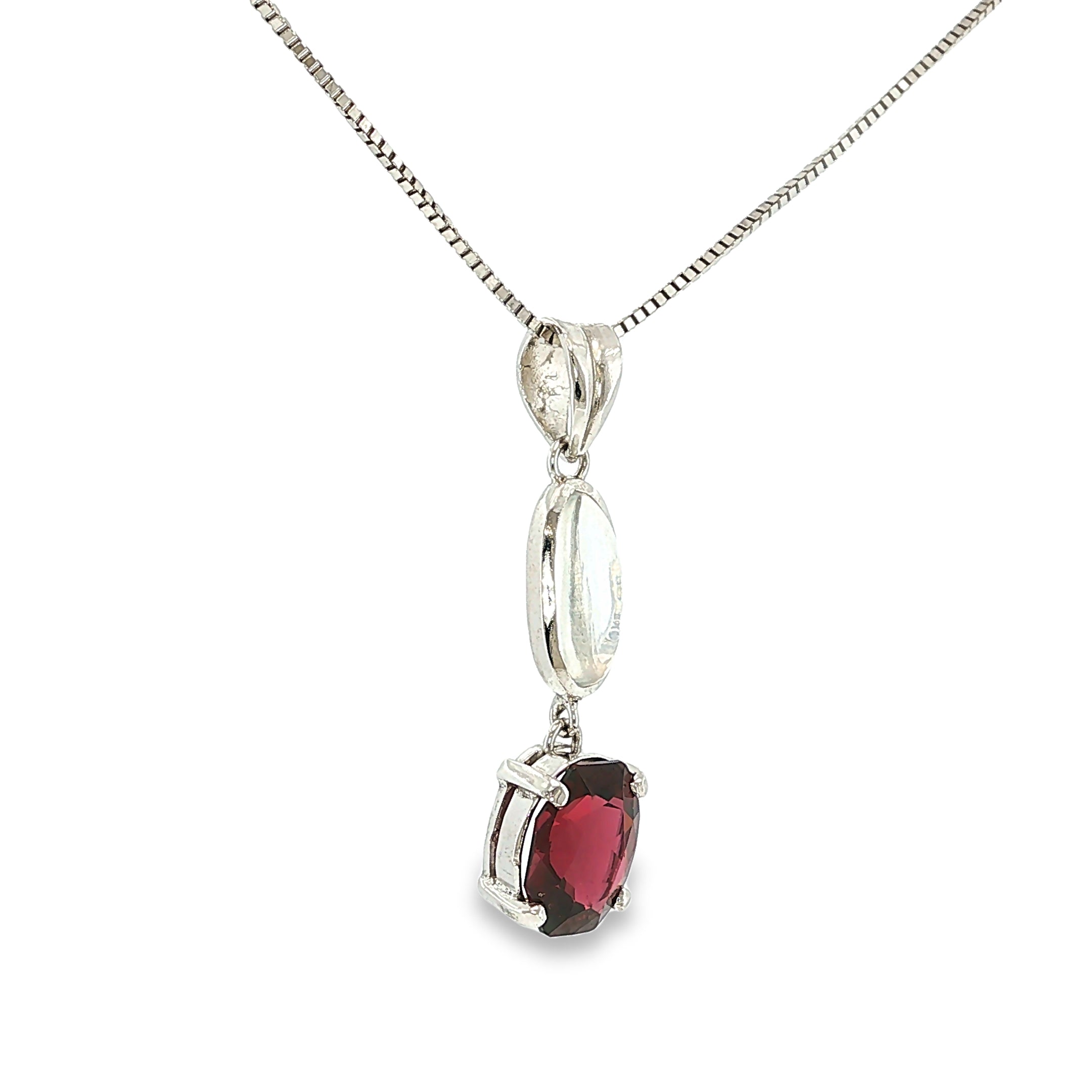 Sterling silver drop pendant featuring a luminous moonstone accented by a red garnet.