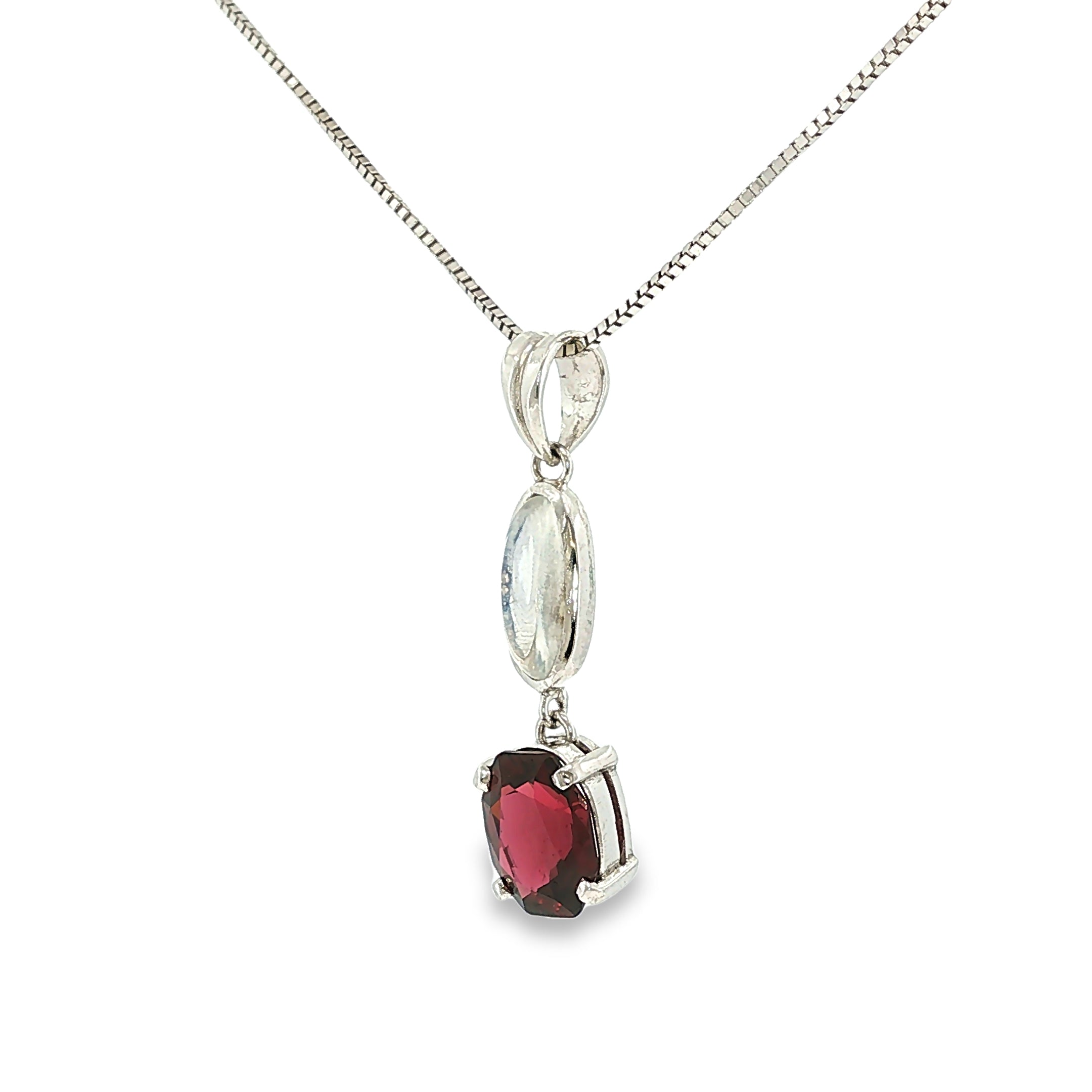Sterling silver drop pendant featuring a luminous moonstone accented by a red garnet.