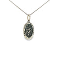 Sterling silver oval Saint Christopher medal pendant with raised religious detailing.