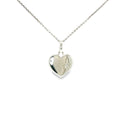 Polished sterling silver flat heart pendant with a small cubic zirconia accent.