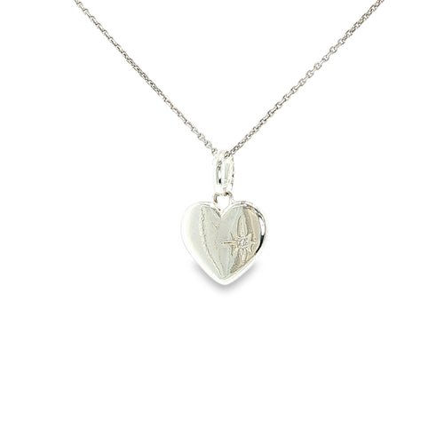 Polished sterling silver flat heart pendant with a small cubic zirconia accent.