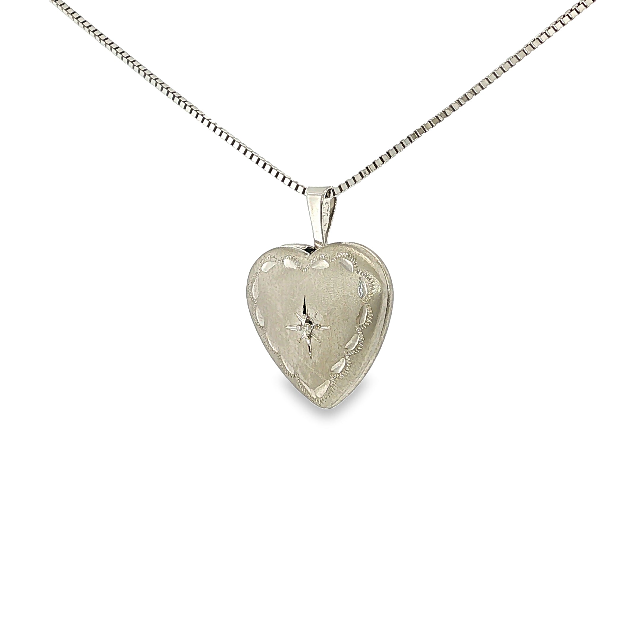 Satin-finished sterling silver heart locket with engraved detailing and a single diamond accent.