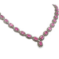 14K white gold pink sapphire and diamond necklace with oval pink sapphires, diamond halos, and a graduated center drop.