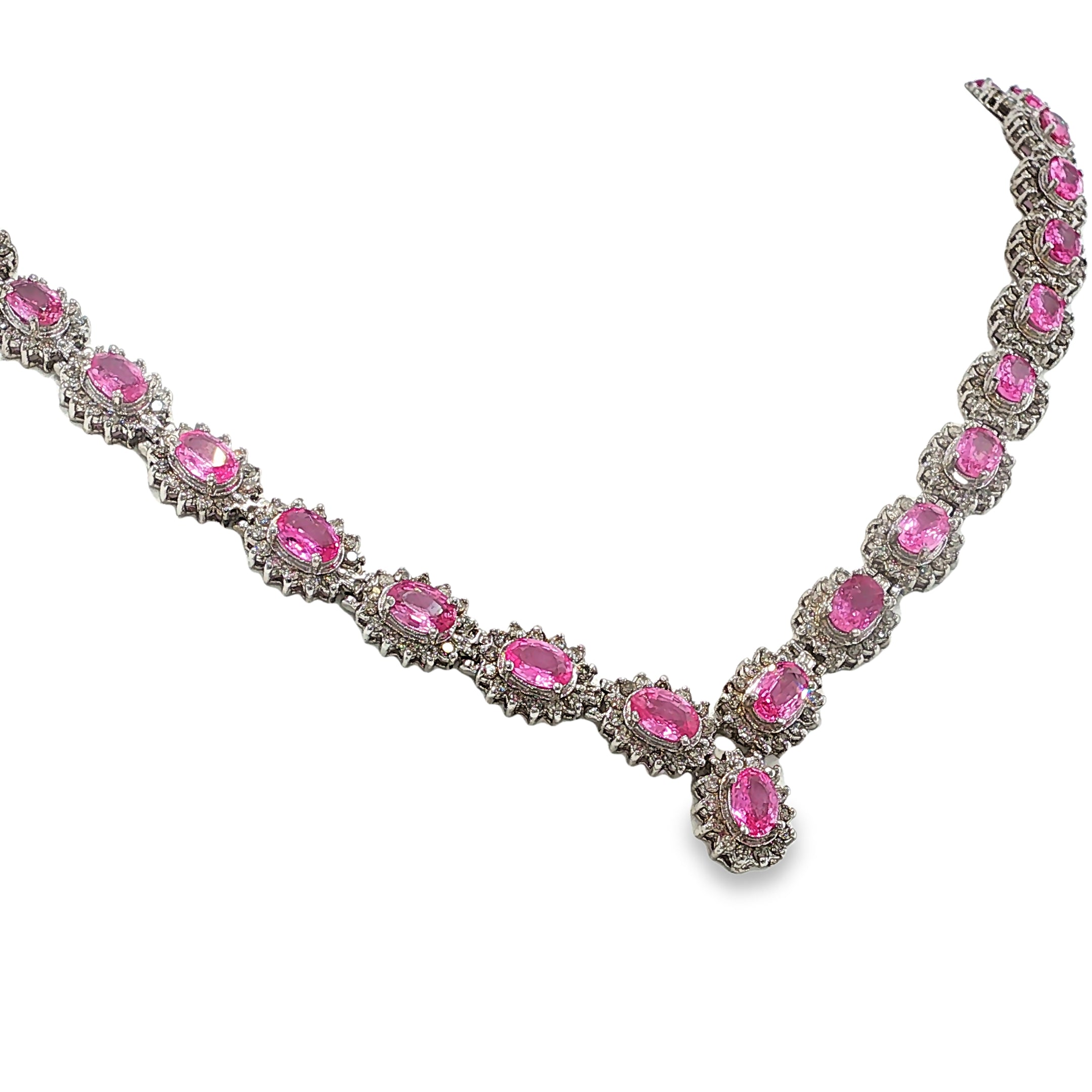 14K white gold pink sapphire and diamond necklace with oval pink sapphires, diamond halos, and a graduated center drop.