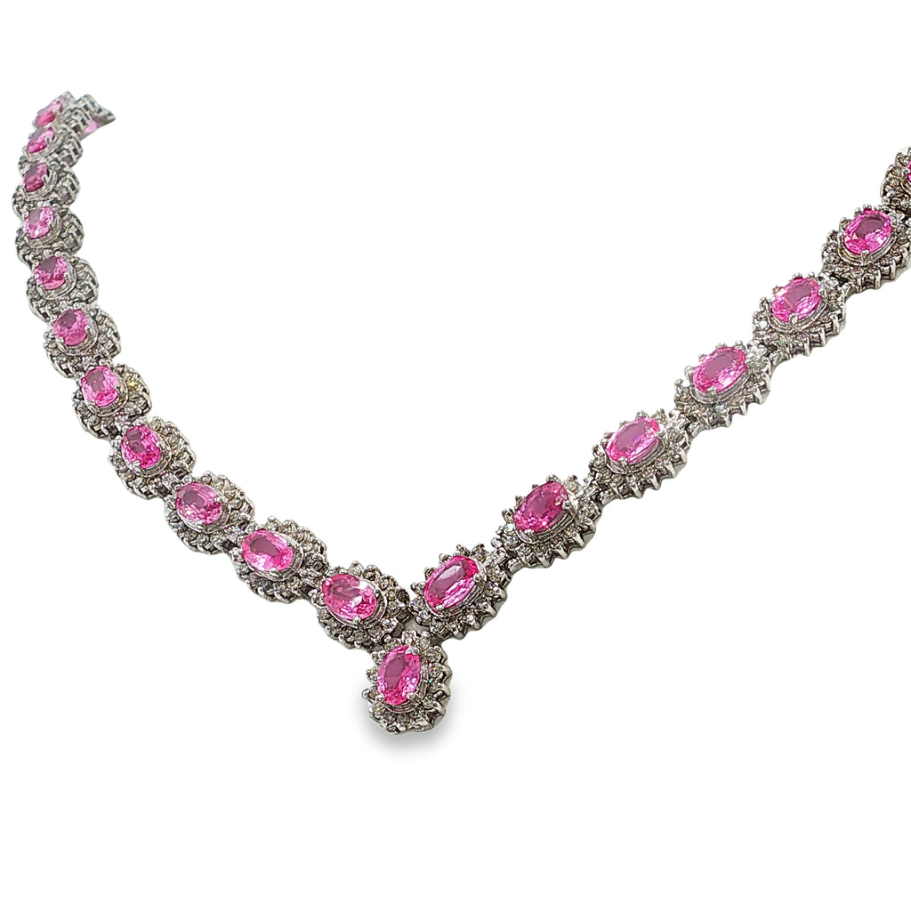 14K white gold pink sapphire and diamond necklace with oval pink sapphires, diamond halos, and a graduated center drop.